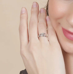 A woman clutches a cup of coffee, showcasing a Tizzarat Sliver Hug Ring.	